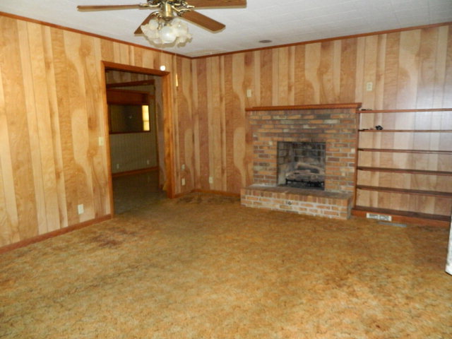 426 Huckabee Road Gray, GA 31032 - Photo 10 of 40 a view of an empty room with a fireplace and a window