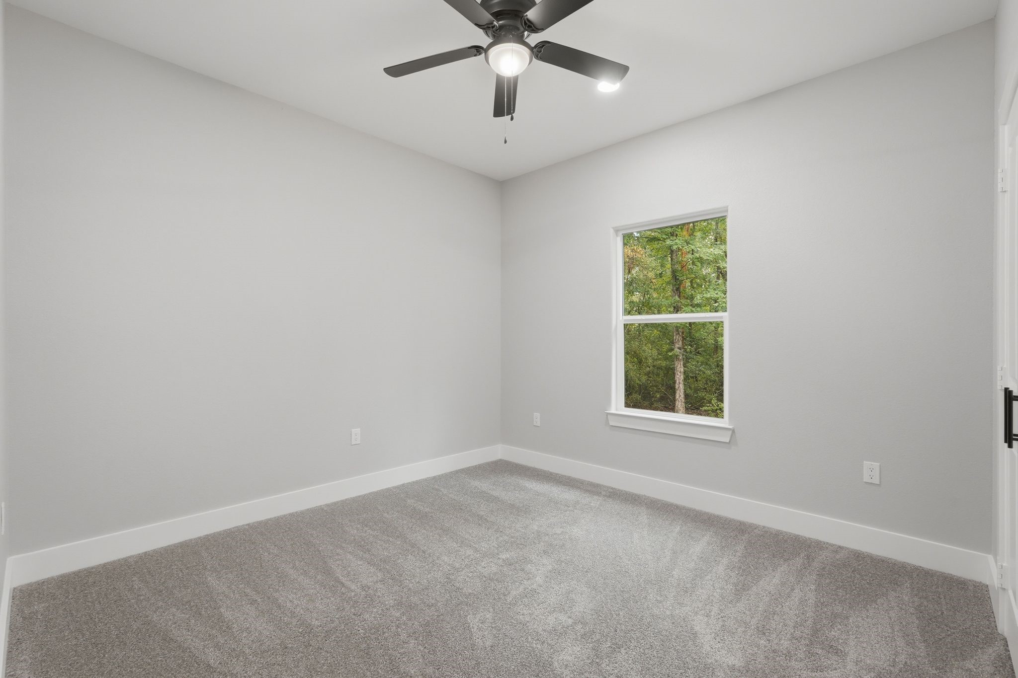 3575 Roy Bean Road Willis, TX 77378 - Photo 26 of 40 an empty room with a window and a fan