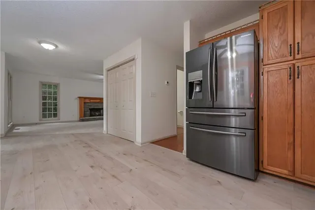 a kitchen with stainless steel appliances granite countertop a refrigerator and a refrigerator