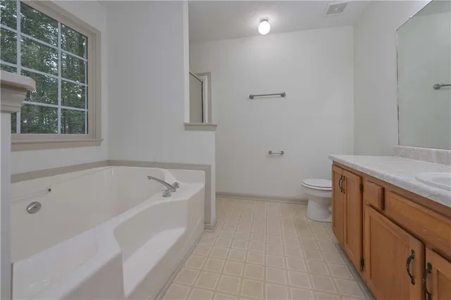 a spacious bathroom with sink and a bathtub