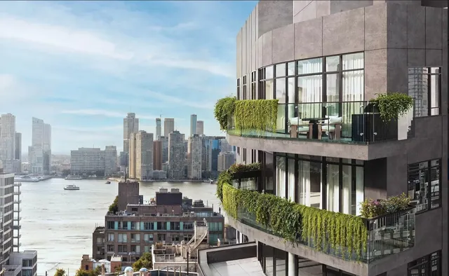 a balcony with outdoor seating and city view