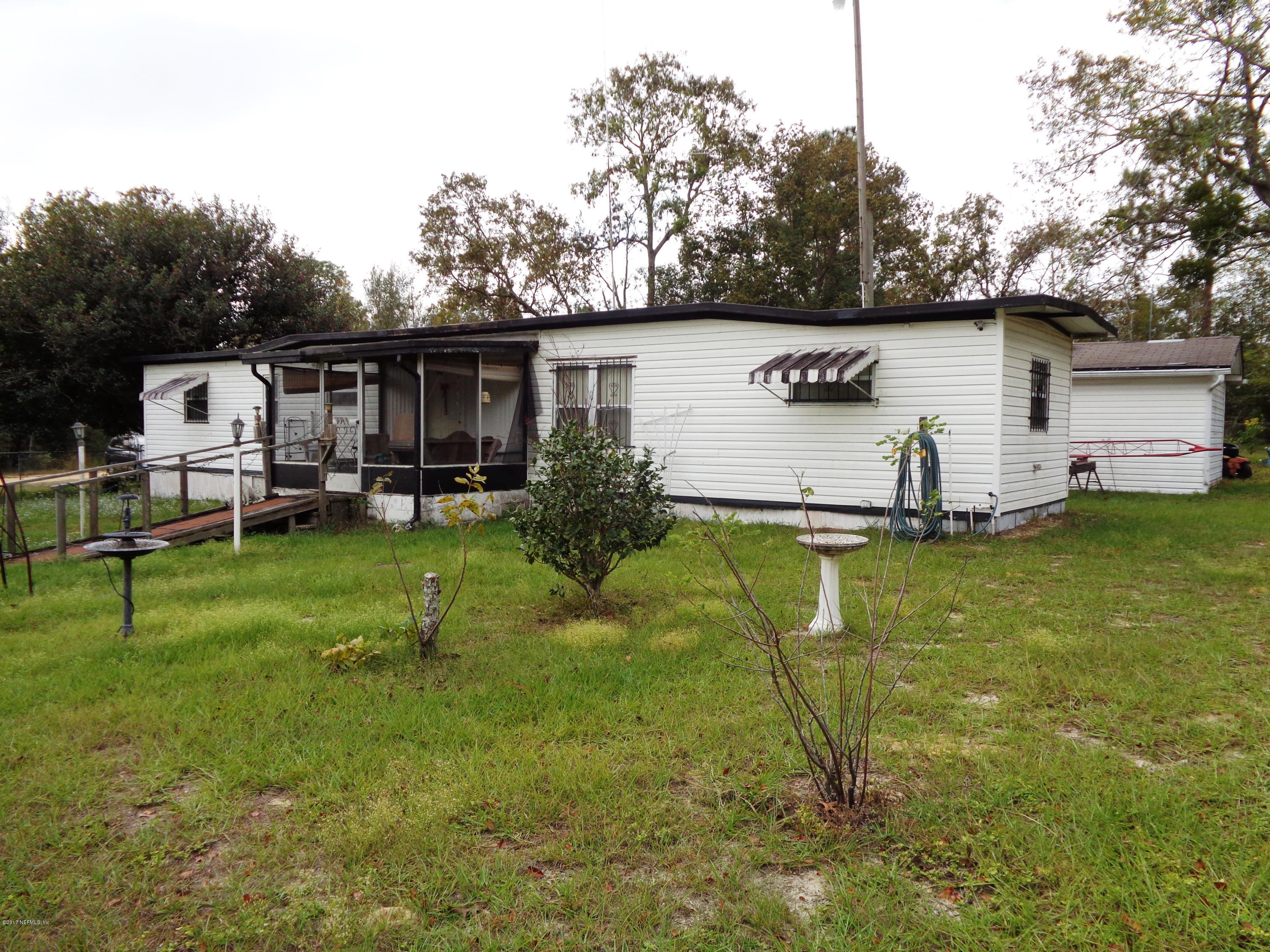 137 Istanbul Street Interlachen, FL 32148 - Photo 1 of 18 a view of a backyard with table and chairs couches fire pit and yard