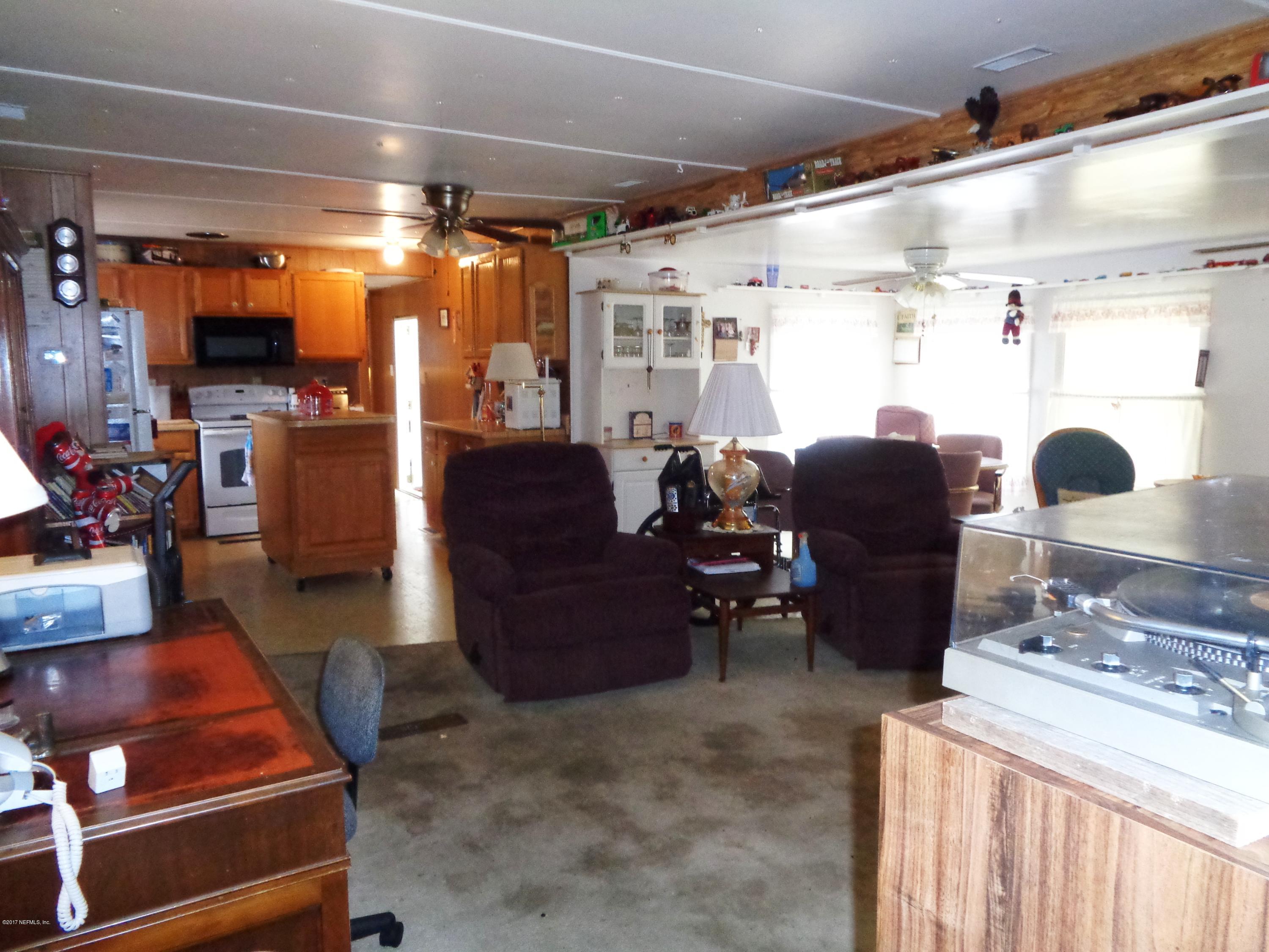 137 Istanbul Street Interlachen, FL 32148 - Photo 16 of 18 a living room with couch and a table