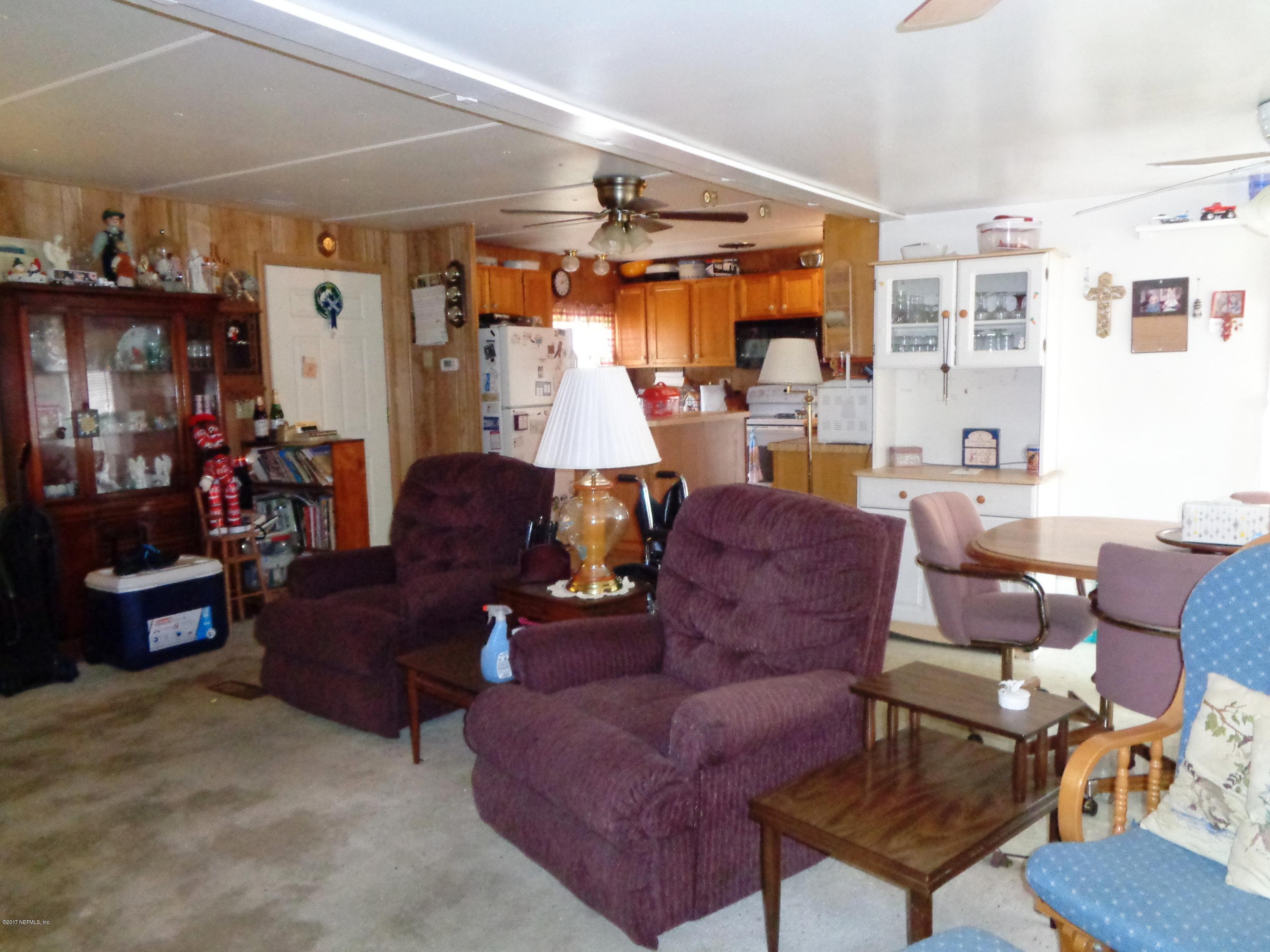 137 Istanbul Street Interlachen, FL 32148 - Photo 17 of 18 a living room with furniture and a large window