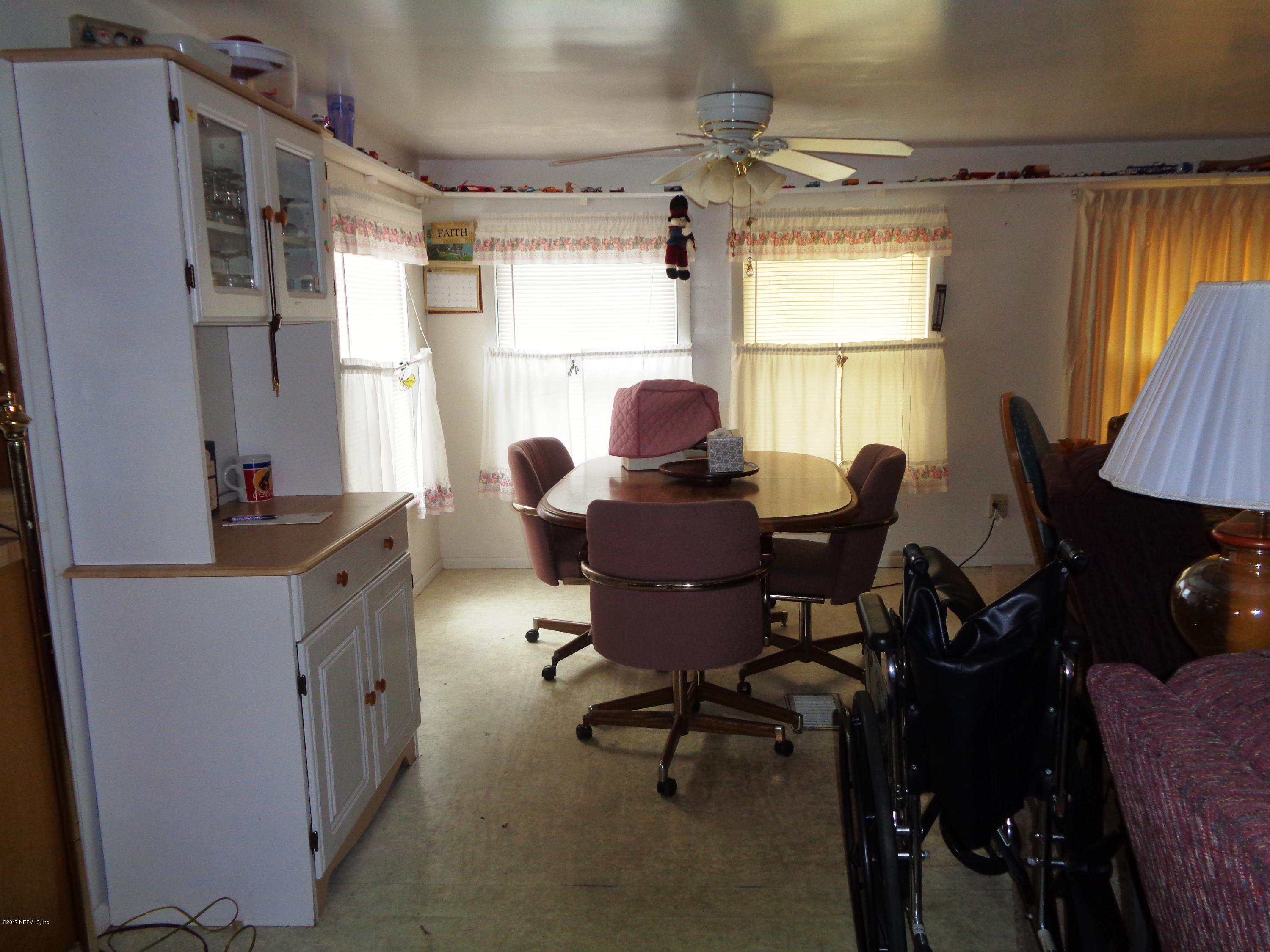 137 Istanbul Street Interlachen, FL 32148 - Photo 6 of 18 a view of a workspace with furniture and a window
