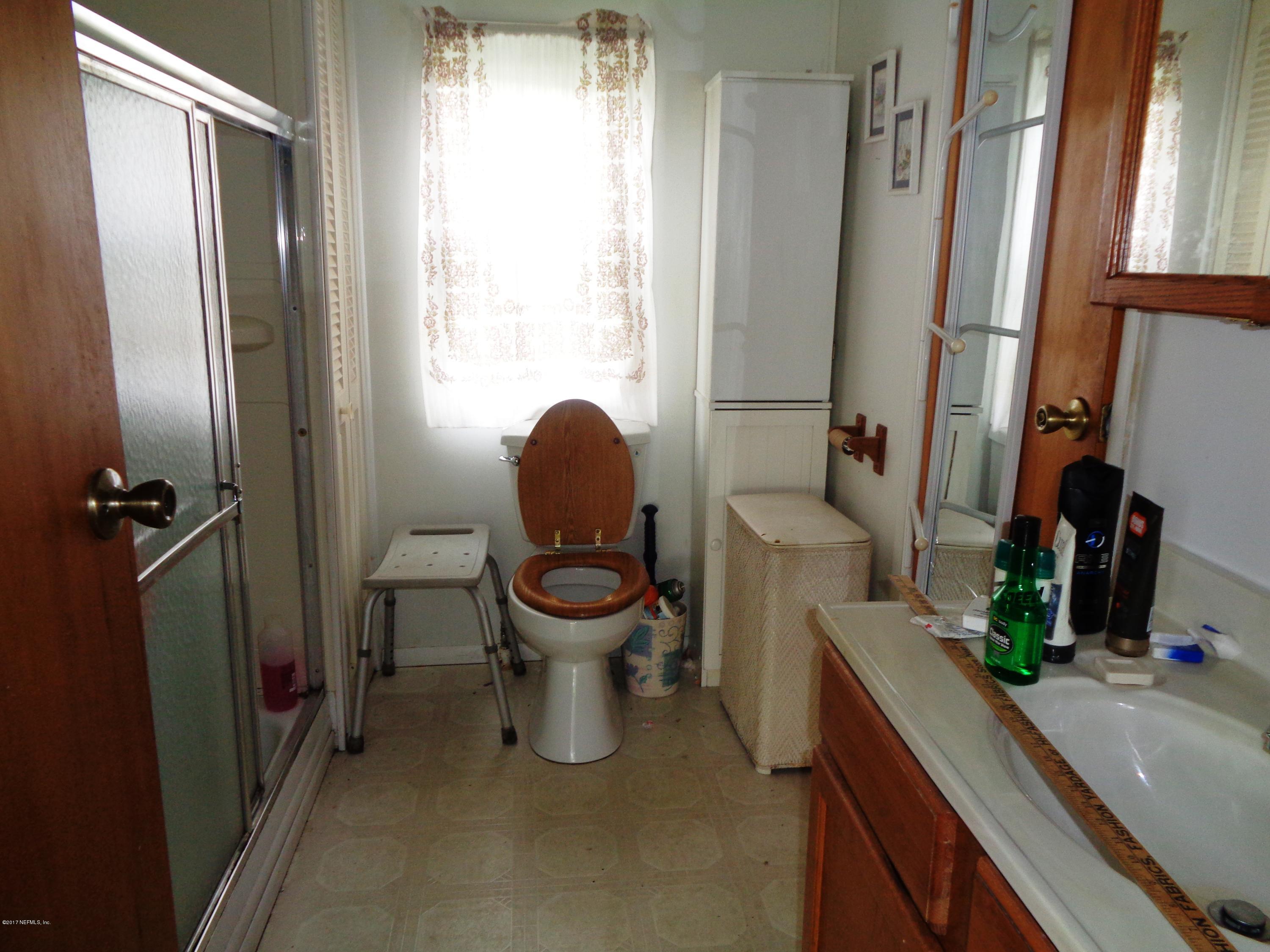 137 Istanbul Street Interlachen, FL 32148 - Photo 10 of 18 a white toilet sitting next to a bathroom sink