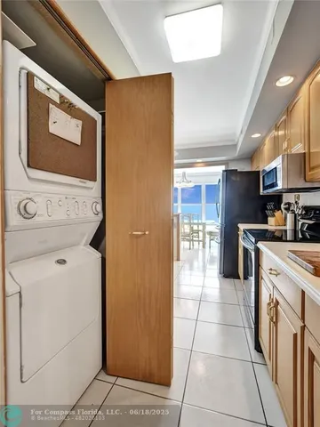 a kitchen with stainless steel appliances granite countertop a refrigerator and a stove