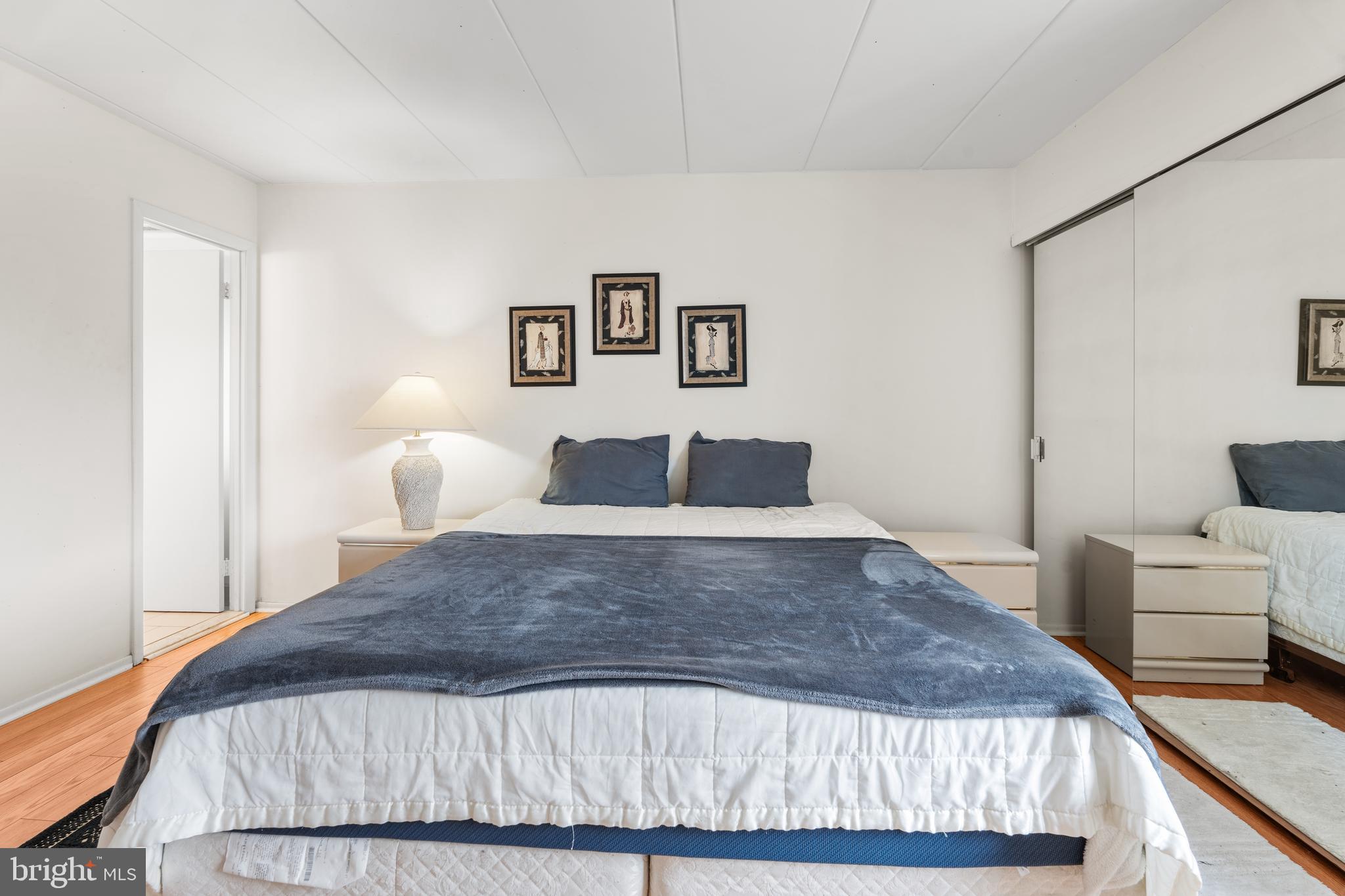 9945 Norwalk Road, Unit 15A Philadelphia, PA 19115 - Photo 14 of 23 a bedroom with a bed and lamp