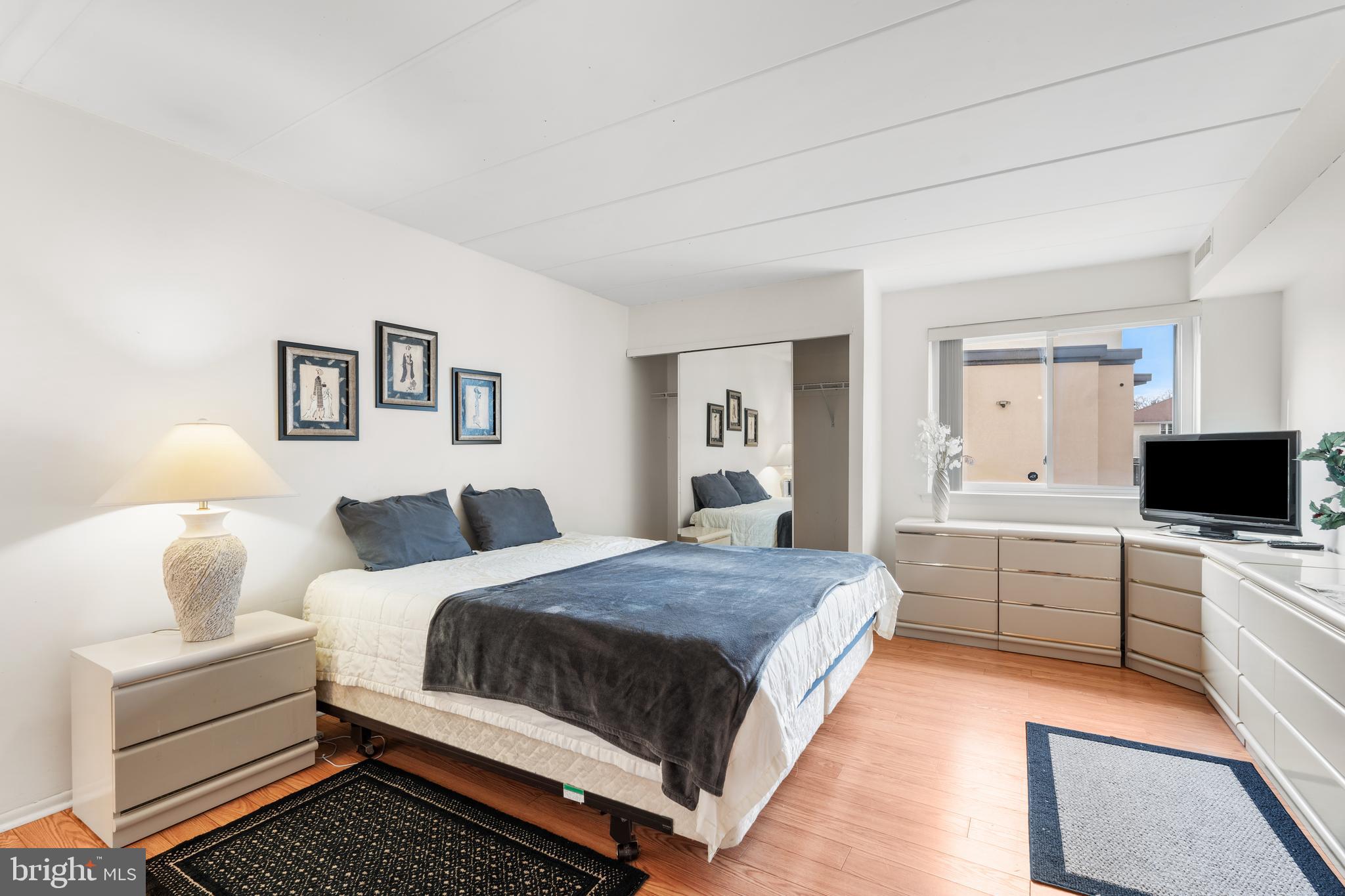 9945 Norwalk Road, Unit 15A Philadelphia, PA 19115 - Photo 16 of 23 a spacious bedroom with a bed and a flat screen tv