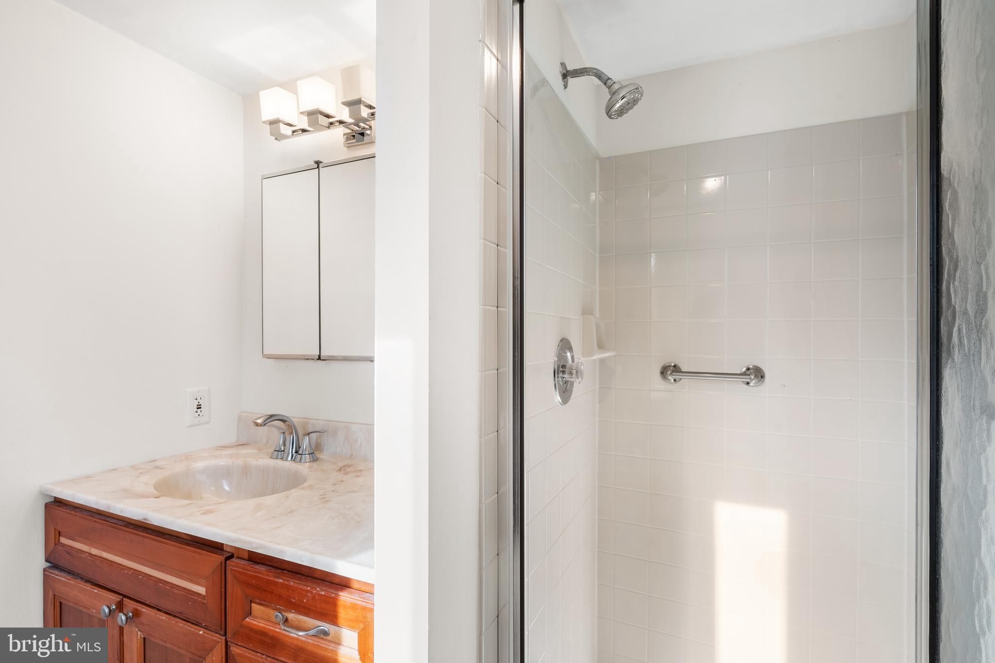 9945 Norwalk Road, Unit 15A Philadelphia, PA 19115 - Photo 18 of 23 a bathroom with a sink vanity and shower