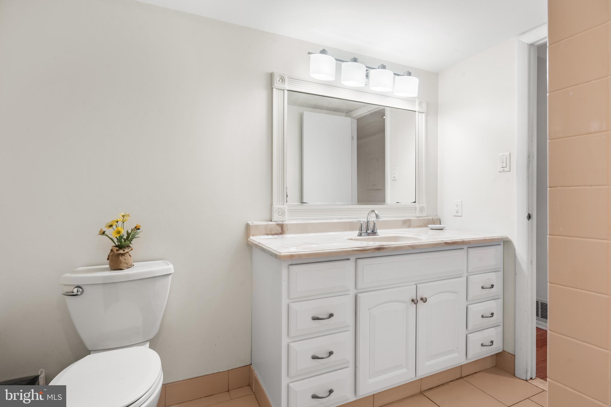 9945 Norwalk Road, Unit 15A Philadelphia, PA 19115 - Photo 23 of 23 a bathroom with a toilet sink and mirror