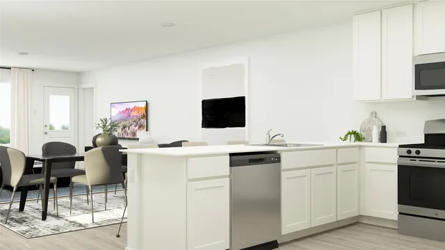 a kitchen with stainless steel appliances granite countertop a dining table chairs and a refrigerator