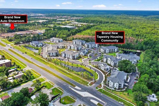 a view of a tennis ground with large trees