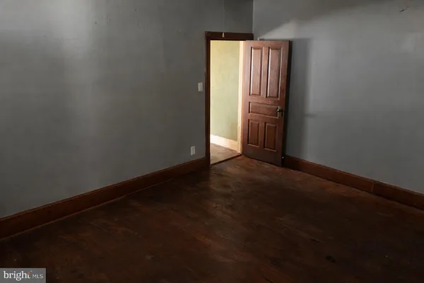 a view of an empty room with wooden door