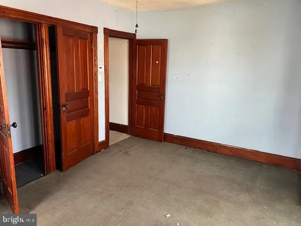 an empty room with closet area