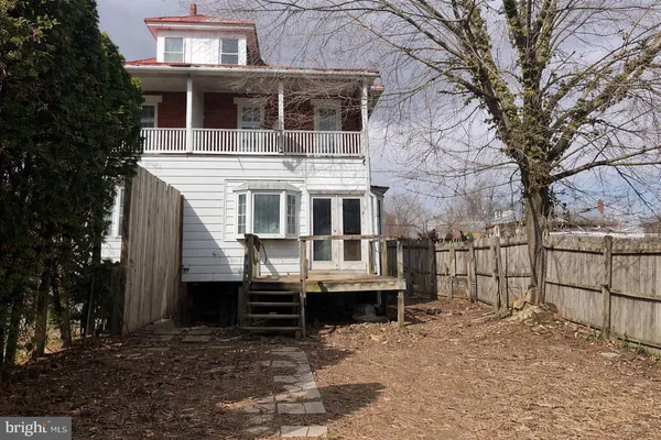 a view of a backyard with a small cabin and a chair