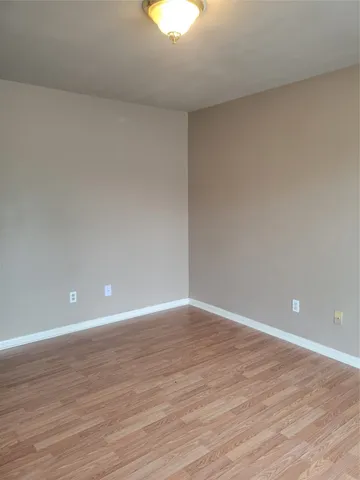 a view of an empty room and wooden floor