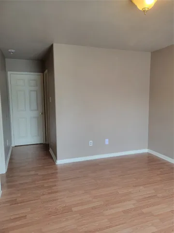 a view of an empty room and wooden floor