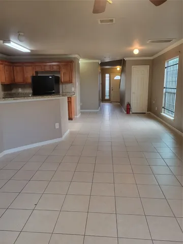 a view of a livingroom with an empty space and a window