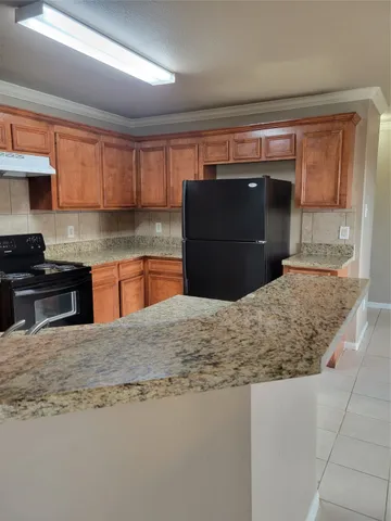a kitchen with stainless steel appliances granite countertop a sink stove and microwave