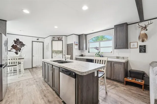 a kitchen with a sink stove and refrigerator