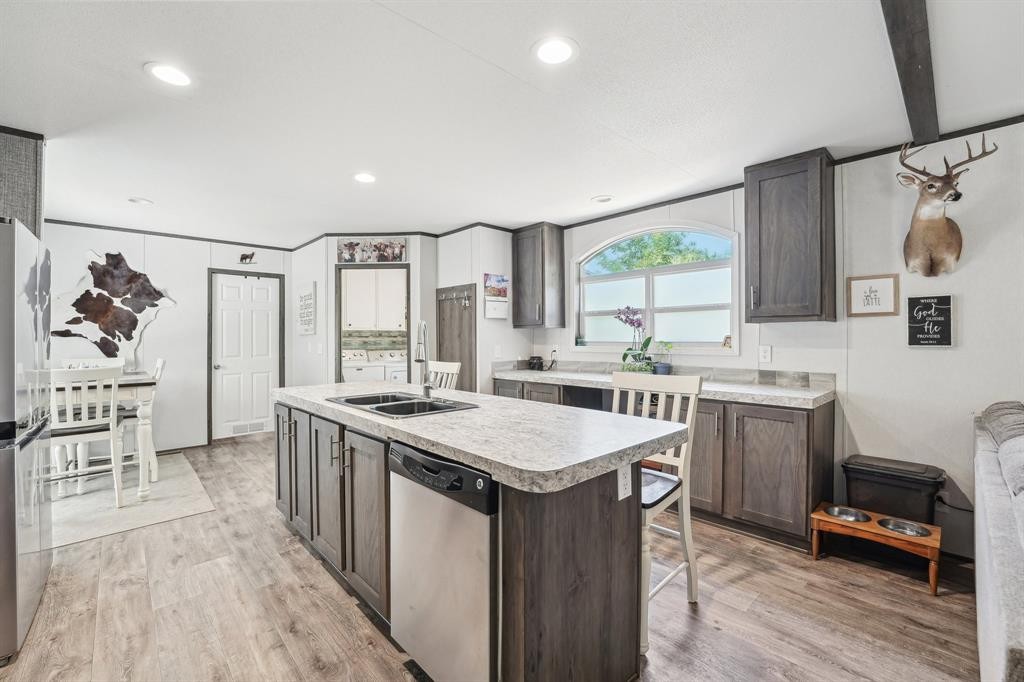 21472 Coyote Trail Lago Vista, TX 78645 - Photo 3 of 11 a kitchen with a sink stove and refrigerator