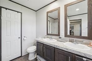 21472 Coyote Trail Lago Vista, TX 78645 - Photo 7 of 11 a bathroom with a granite countertop sink toilet and shower