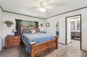 21472 Coyote Trail Lago Vista, TX 78645 - Photo 10 of 11 a bed room with a bed and a chandelier