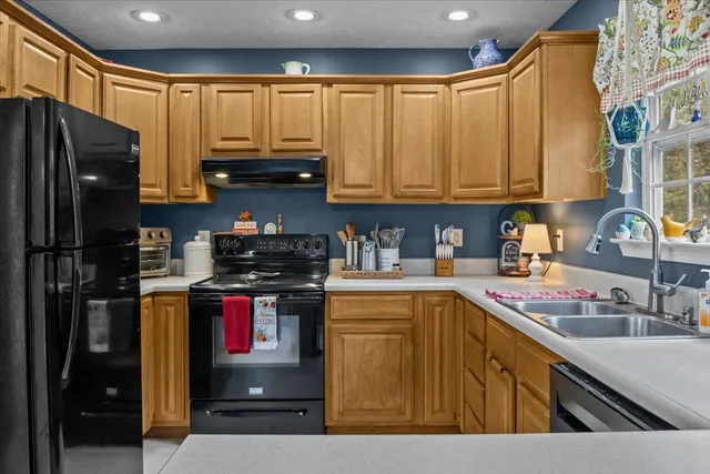 a kitchen with a refrigerator and a sink