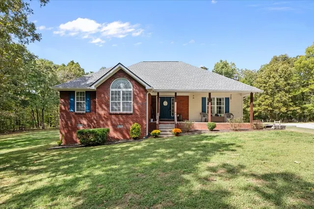 a front view of a house with a garden and porch