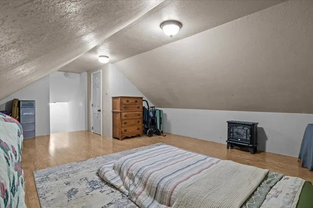 a bedroom with a bed and a television