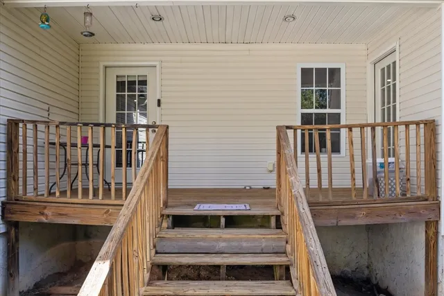 a view of balcony with wooden floor and fence