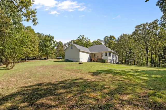 a yellow house with trees in front of it