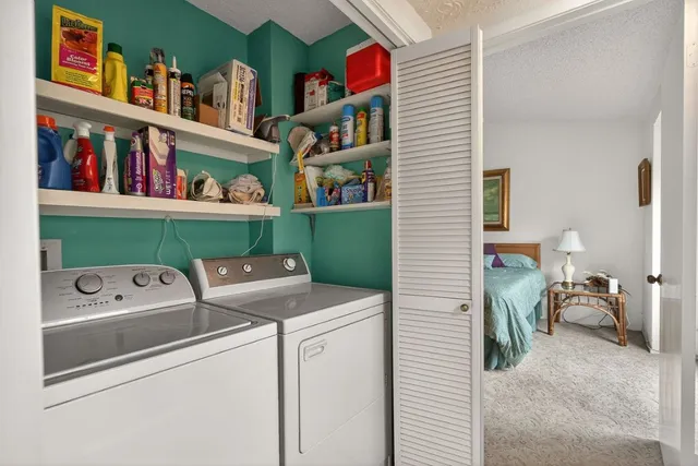 a utility room with dryer washer and shoe rack