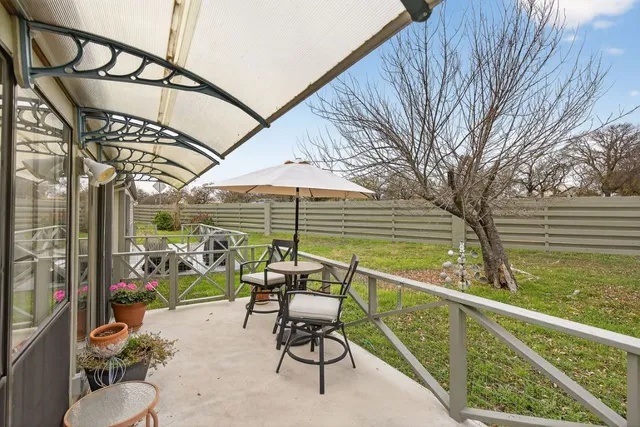 a view of a chair and tables in the balcony