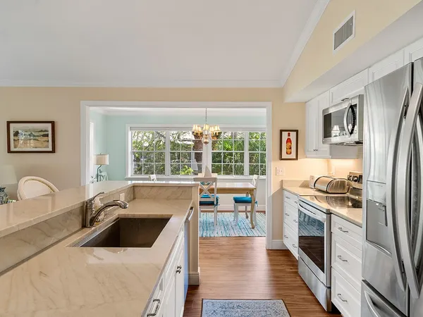 a kitchen with a stove a sink and a refrigerator