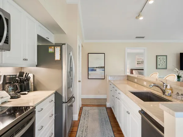 a kitchen with a sink stove and refrigerator