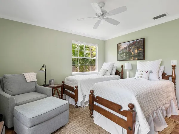 a bedroom with a bed a couch and a window