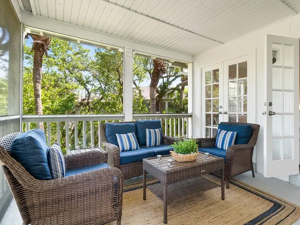 a balcony with furniture and a potted plant