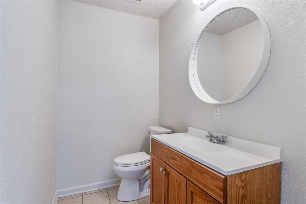 11348 McCree Road Dallas, TX 75238 - Photo 11 of 15 a bathroom with a sink and a mirror