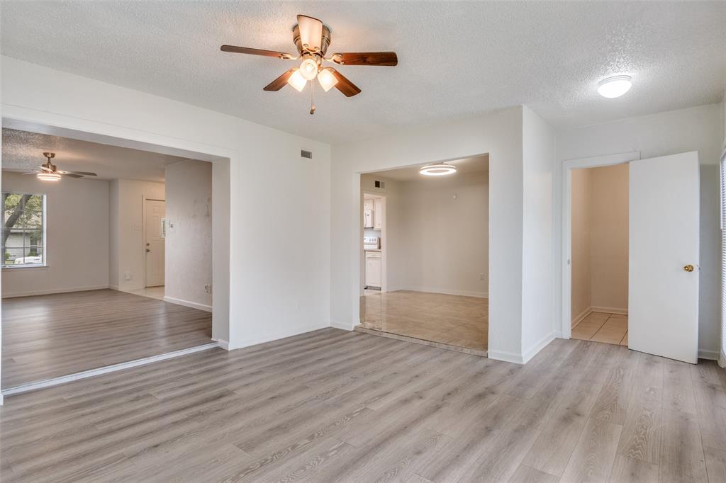 11348 McCree Road Dallas, TX 75238 - Photo 3 of 15 a view of empty room with wooden floor and ceiling fan