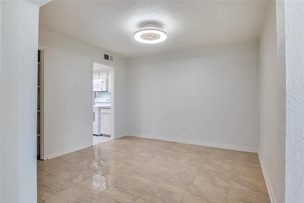 a view of an empty room and a window