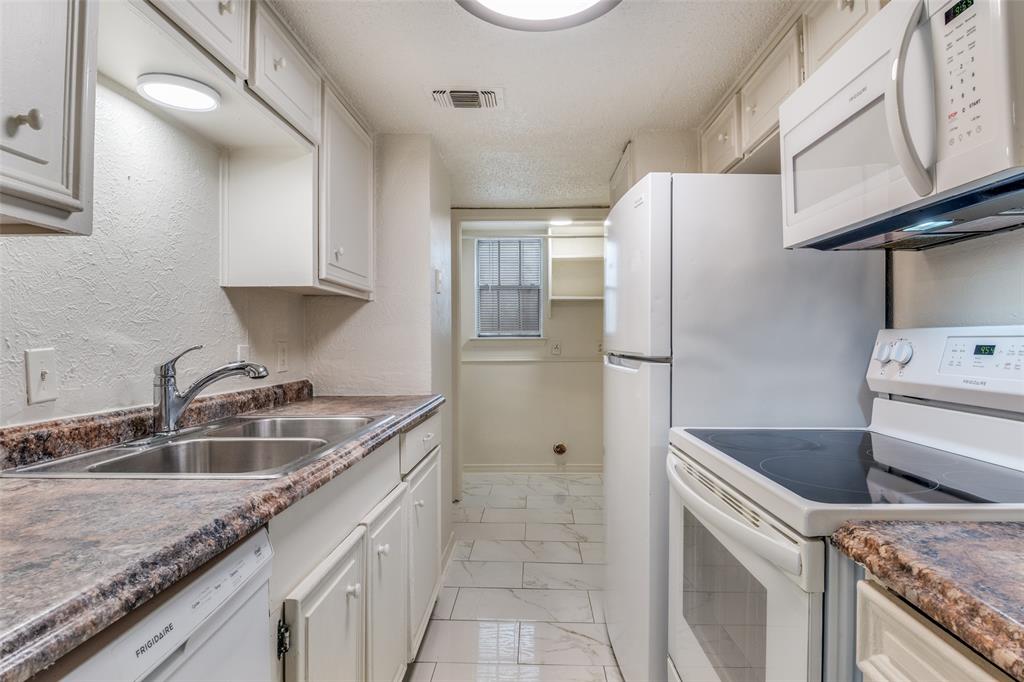 11348 McCree Road Dallas, TX 75238 - Photo 5 of 15 a kitchen with granite countertop a sink and a refrigerator