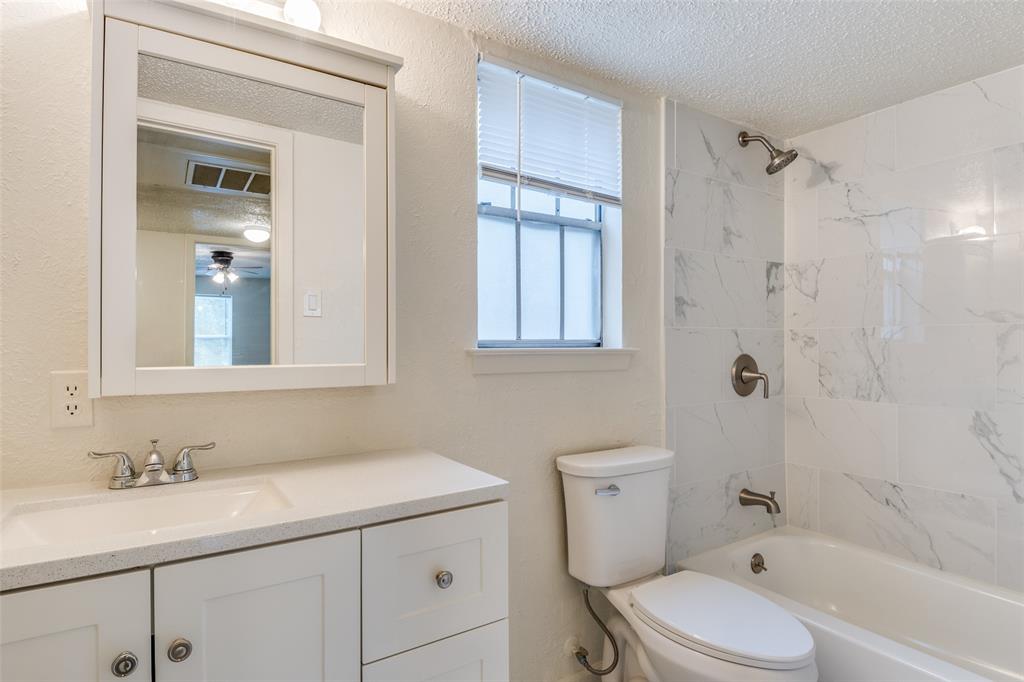 11348 McCree Road Dallas, TX 75238 - Photo 8 of 15 a bathroom with a sink a toilet and shower