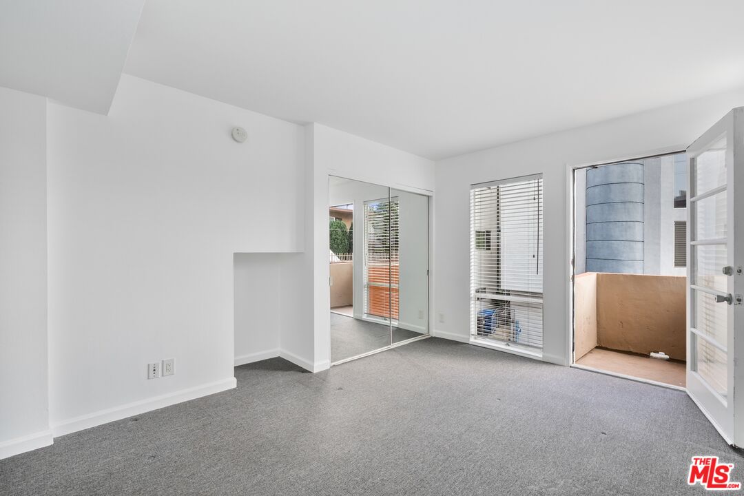 110 Fleet Street Marina del Rey, CA 90292 - Photo 11 of 18 an empty room with a cabinet and mirrors