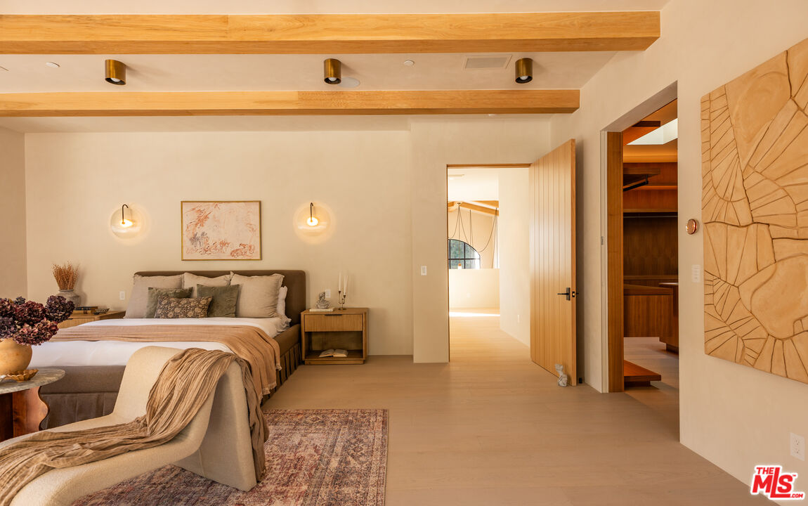 966 Stone Canyon Road Los Angeles, CA 90077 - Photo 12 of 30 a bedroom with a bed and a refrigerator