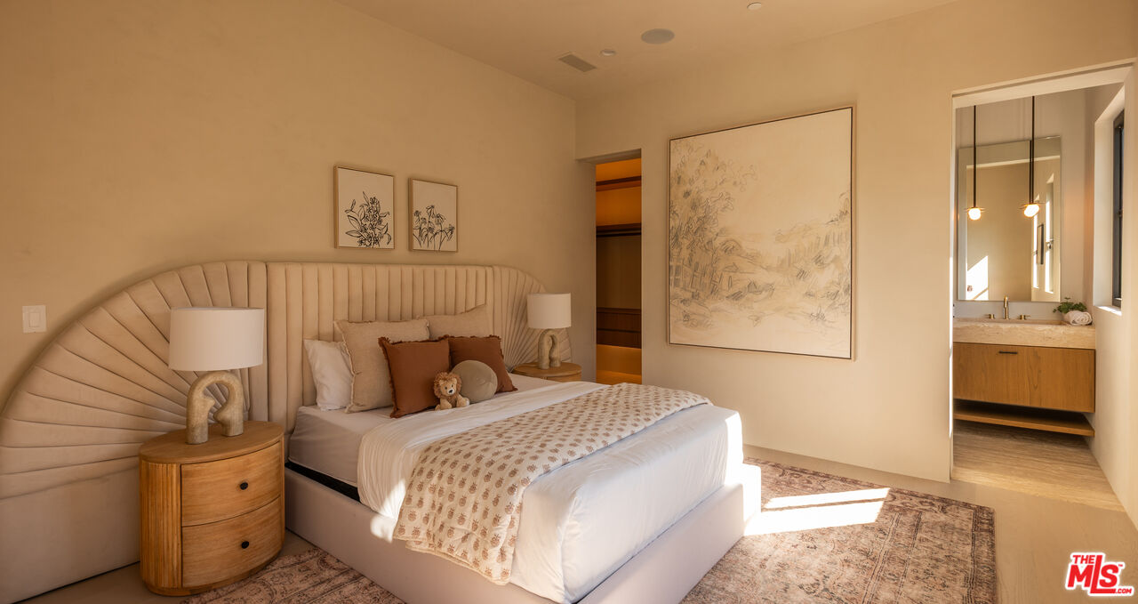 966 Stone Canyon Road Los Angeles, CA 90077 - Photo 16 of 30 a bedroom with a bed and a view of bathroom
