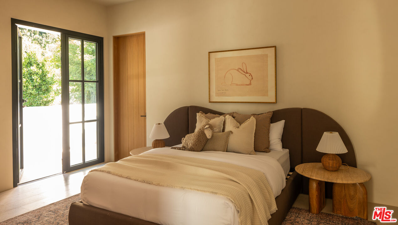 966 Stone Canyon Road Los Angeles, CA 90077 - Photo 17 of 30 a bedroom with a bed and window
