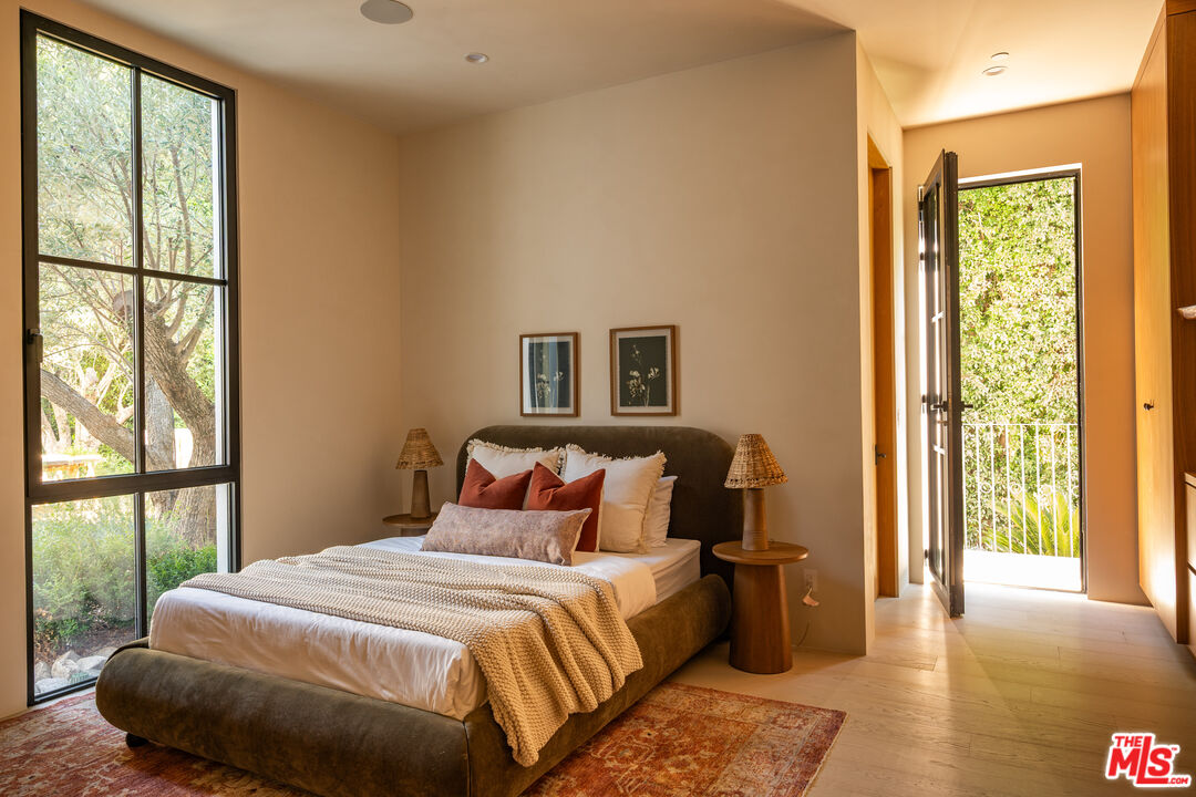 966 Stone Canyon Road Los Angeles, CA 90077 - Photo 20 of 30 a bedroom with a large bed and a large window