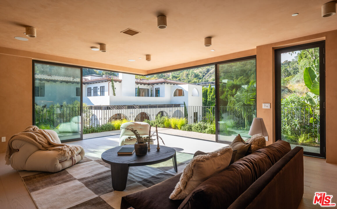 966 Stone Canyon Road Los Angeles, CA 90077 - Photo 21 of 30 a living room with furniture and a large window